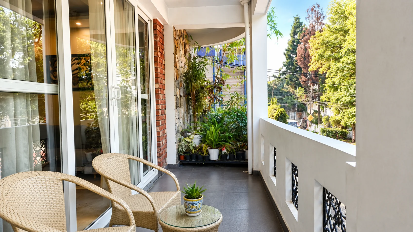 Chic bedroom balcony overlooking Dalanwala scenic green views in our Dehradun homestay